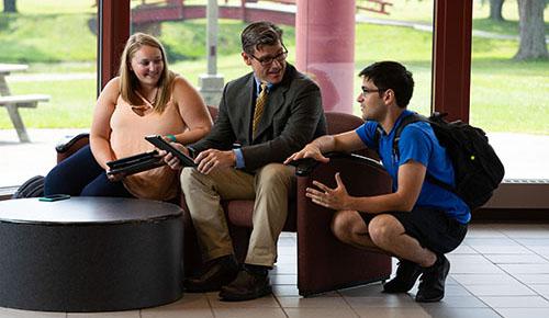 A professor talking with students