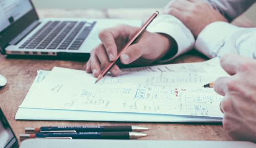 A person writing on a piece of paper