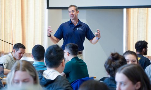 Dr. Kollmann enthusiastically speaking to the audience at Northeast College
