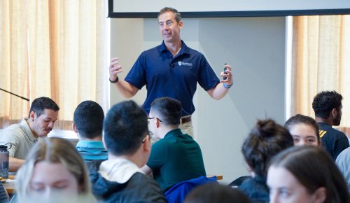 Dr. Kollmann speaking to a crowd