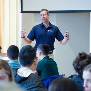 Dr. Kollmann speaking enthusiastically