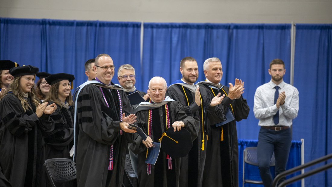 faculty members applauding