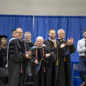 faculty members applauding