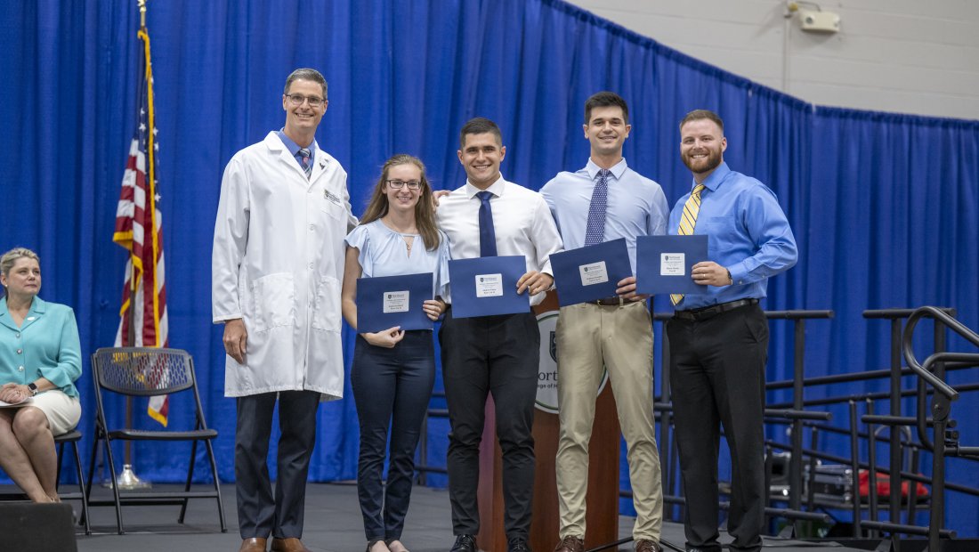 a group of students receive recognition