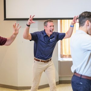 Dr. Kollmann leading the crowd in a roar to get them pumped