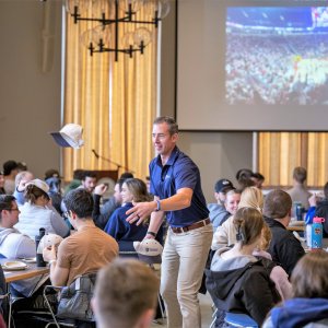 Dr. Kollmann tossing a hat to an audience member