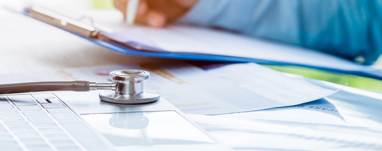 close up of medical professional completing paperwork