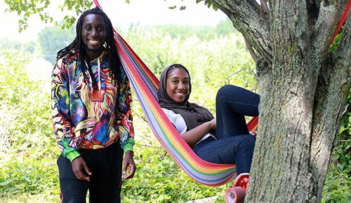 Northeast students standing by a hammock