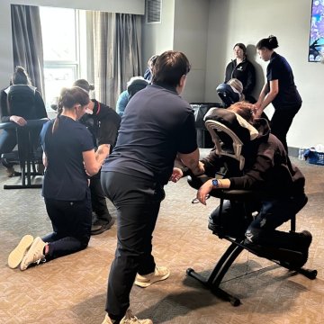 massage therapy students giving massages during a Regional EMS Conference