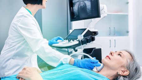 A sonographer working with a patient