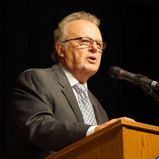 Dr. Thomas Ventimiglia speaking from a podium