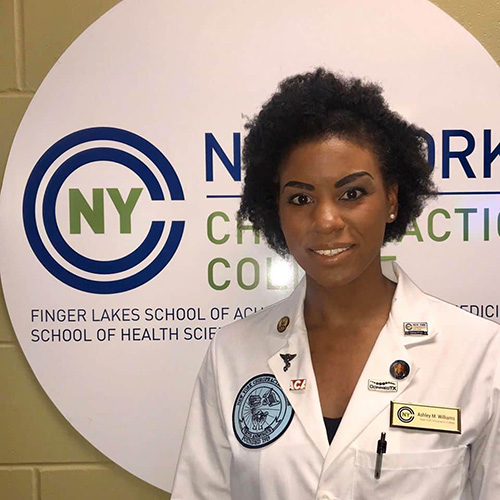 Ashley Williams headshot wearing a white coat