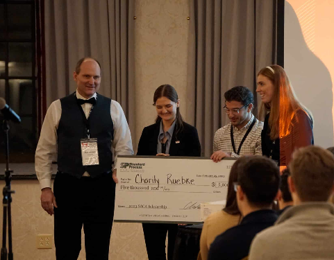 students posing with oversized check